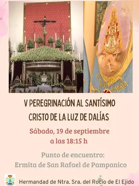 Altar con imagen del Cristo crucificado rodeado de flores blancas y estandarte bordado con la Virgen del Rocío y texto El Ejido Almería