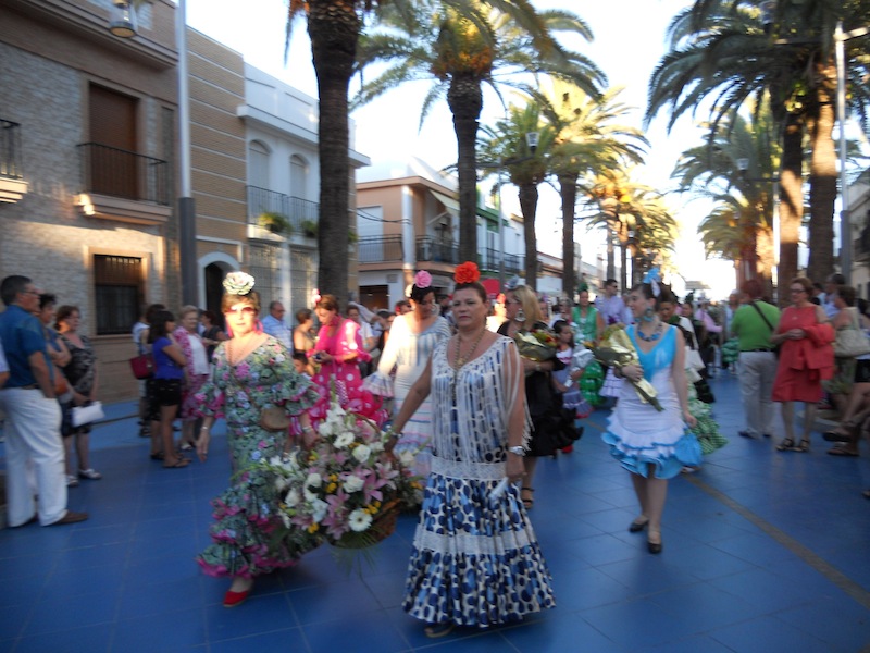 Por Las Palmeras haciendo la salida y ante la Virgen del Carmen una vez hecha la ofrenda de flores y alimentos.