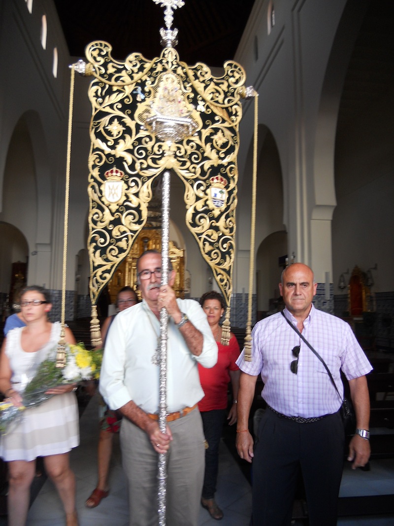 El Presidente, Francisco Amorós, porta el Simpecado para recibir a la Virgen del Mar a las puertas de la Parroquia de Los Dolores y, al mismo tiempor, haciendo el saludo al Sagrario